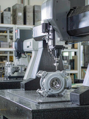 CMM inspection of a machined aluminum robot joint housing on a granite bridge coordinate measuring machine