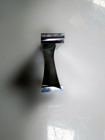 A stainless steel instrument component sample: polished, burr-free, and packed after purified-water cleaning.