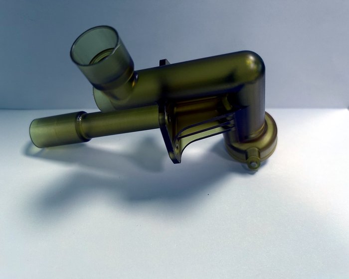 A PEEK branch fitting sample. The organic junction is contoured in one 5-axis setup so wall thickness stays uniform through the branch.