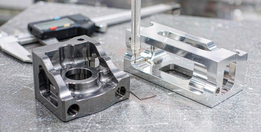 Finished titanium and aluminum structural parts side by side. Material price is a small share of the cost gap; machine time and tooling drive the rest.