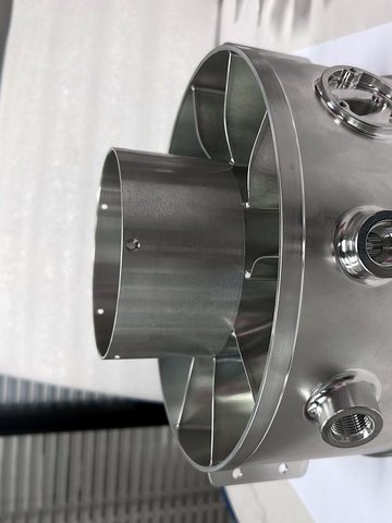 Side view of the housing showing the threaded radial port bosses and the internal vane passages. All features are cut without moving the part.