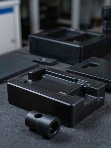 Black ESD-safe plastic fixtures machined for semiconductor test equipment