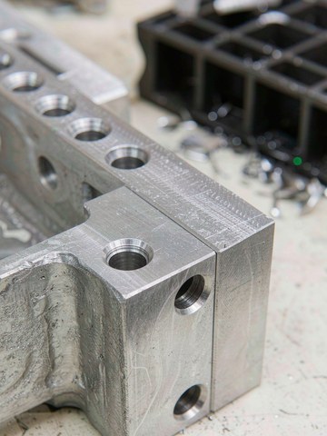 Machined aluminum tool frame interface with reamed dowel holes and a finished datum face