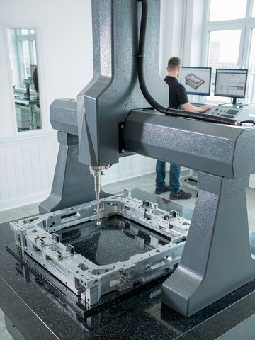 Hexagon bridge CMM verifying hole position and flatness on an aluminum semiconductor equipment frame plate