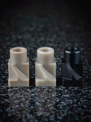Side-by-side comparison of PEEK1000 glass-filled and carbon-filled ESD PEEK machined parts