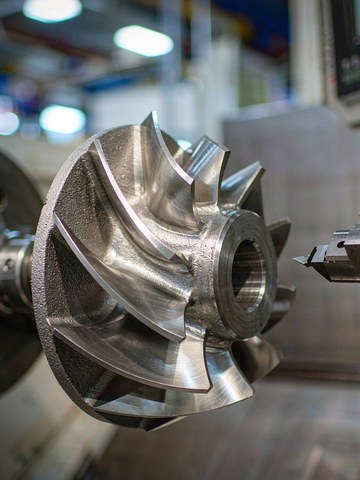 Generated image of a machined impeller with cast surfaces on a workbench