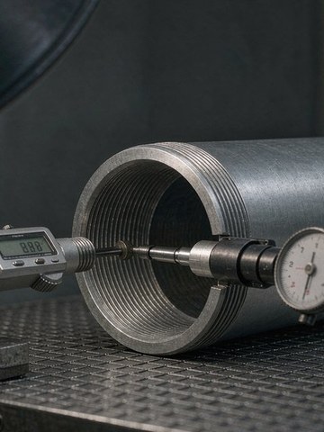 Bore and thread verification on a machined optical lens barrel.