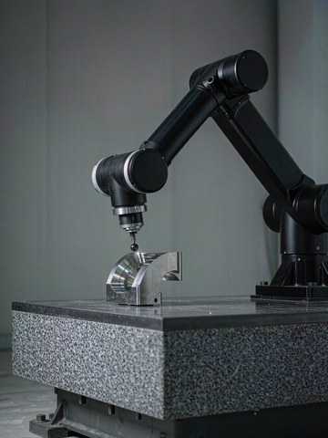 CMM inspection of a crossed-axis robot joint part with coaxiality report on screen