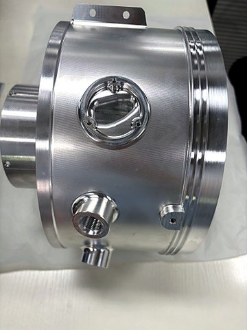 Turbine housing machined on 5-axis centers. The outer cylinder, radial port bosses, and seal grooves are finished from one coordinate origin, keeping every port true to the cylinder axis.
