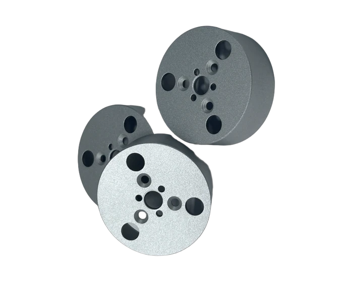 Anodized perforated cylinder end cap, front face with hole pattern