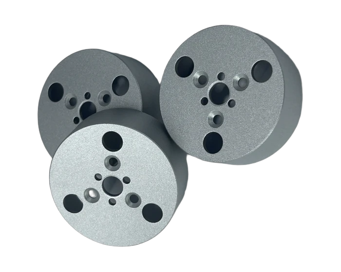 Perforated cylinder end cap, angled view with counterbores